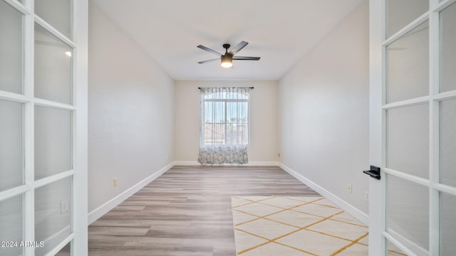 spare room with ceiling fan and light wood-type flooring