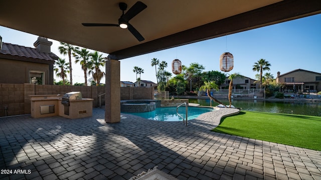 view of swimming pool with an in ground hot tub, a water view, area for grilling, and ceiling fan