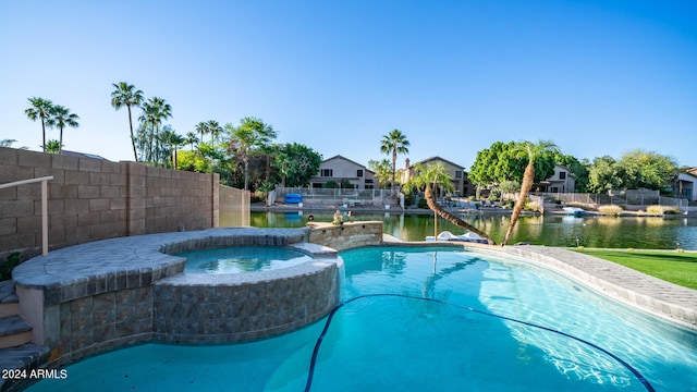 view of pool featuring a water view and an in ground hot tub