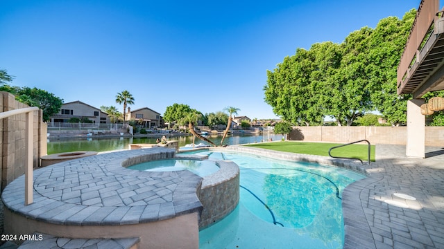 view of pool featuring an in ground hot tub and a water view