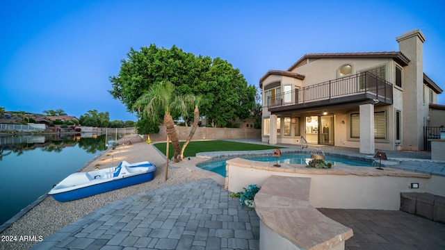 view of pool with a water view and a patio area