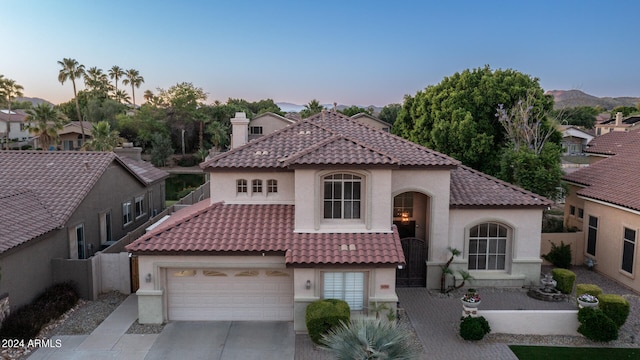 mediterranean / spanish home featuring a garage