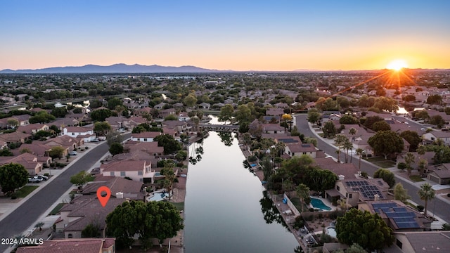 aerial view at dusk with a water and mountain view