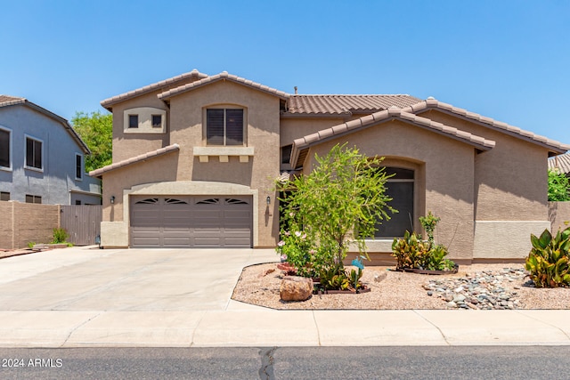 mediterranean / spanish house featuring a garage