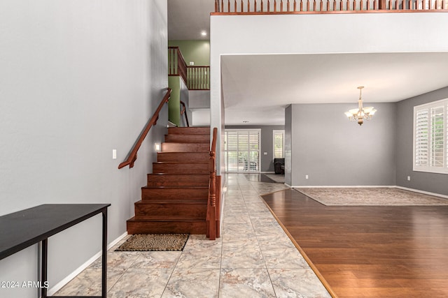 staircase featuring a notable chandelier and hardwood / wood-style floors