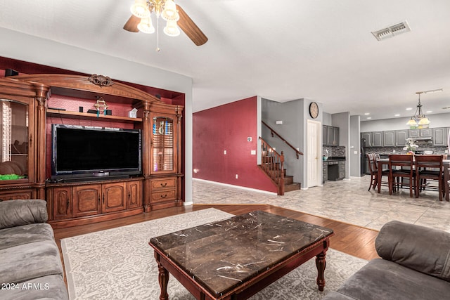 living room with ceiling fan and light hardwood / wood-style floors