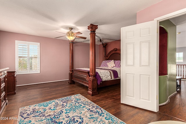 bedroom with dark wood-type flooring, a textured ceiling, and ceiling fan