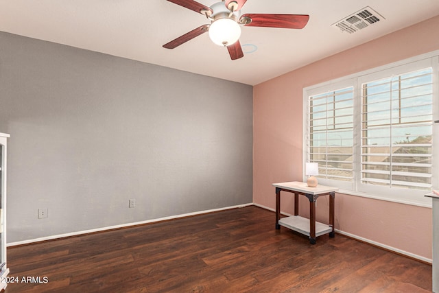 spare room with ceiling fan and dark hardwood / wood-style flooring