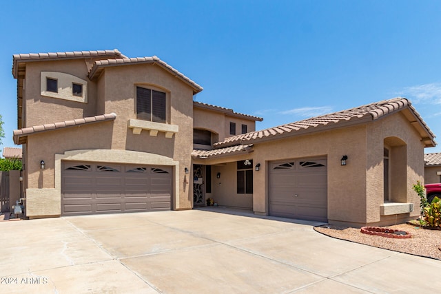 mediterranean / spanish-style house with a garage