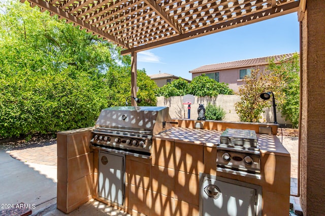 view of patio with a pergola, area for grilling, and a grill