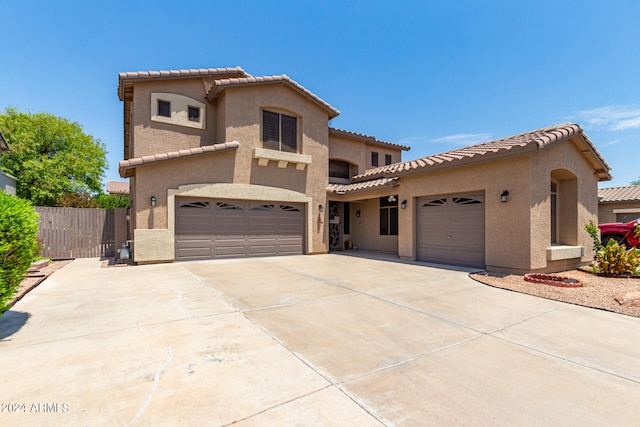 mediterranean / spanish house featuring a garage