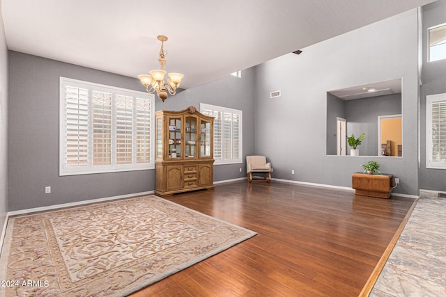 interior space featuring dark wood-type flooring and a chandelier