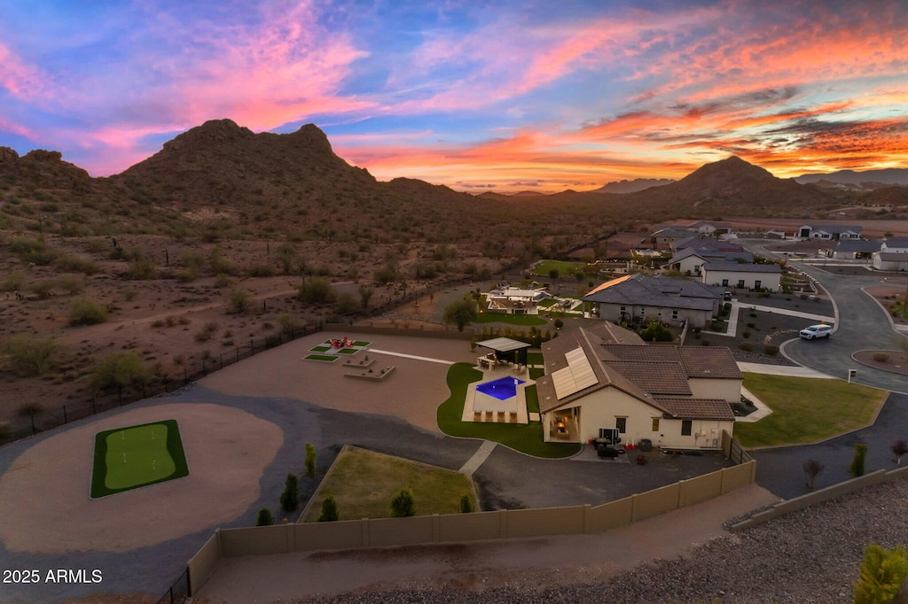 aerial view at dusk featuring a mountain view