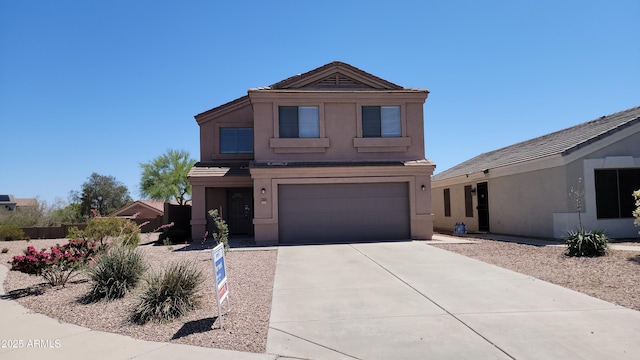 traditional home featuring an attached garage, stucco siding, and driveway