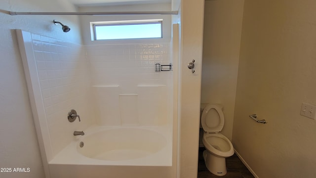 full bathroom with shower / bathing tub combination, toilet, and baseboards