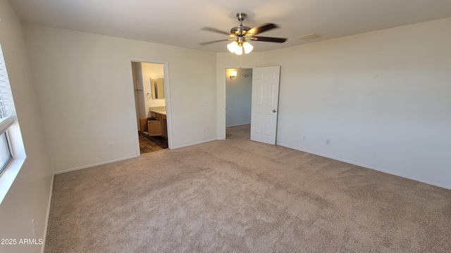 unfurnished bedroom featuring ensuite bathroom, carpet flooring, and baseboards