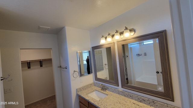 full bathroom featuring vanity and a bath