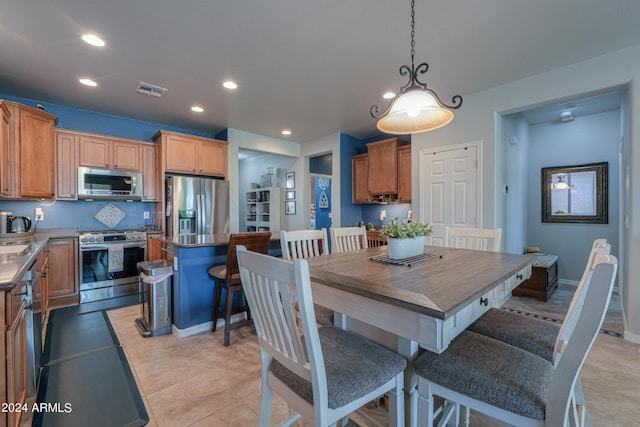 dining area featuring light tile patterned flooring, baseboards, and recessed lighting