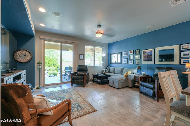 living area featuring a ceiling fan, visible vents, and light tile patterned flooring