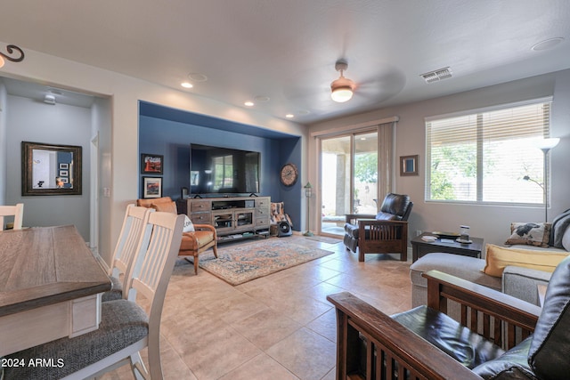 living room featuring baseboards, light tile patterned flooring, visible vents, and recessed lighting