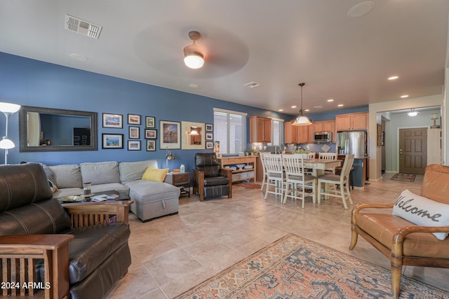 living area featuring recessed lighting, visible vents, and a ceiling fan