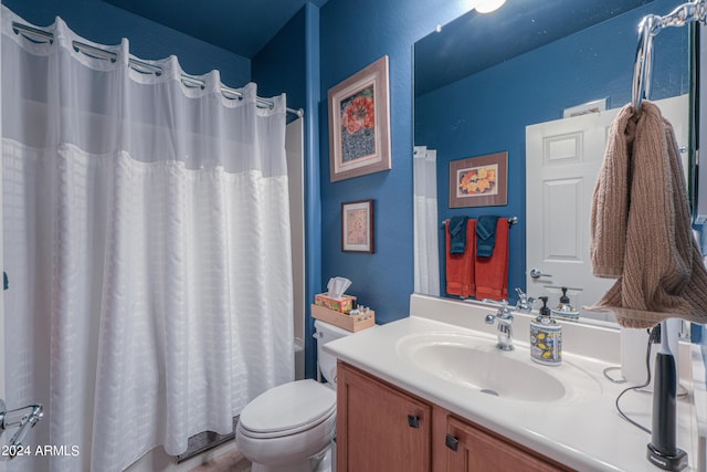 bathroom with toilet, curtained shower, and vanity