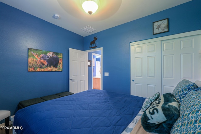 bedroom with a closet, visible vents, and ceiling fan