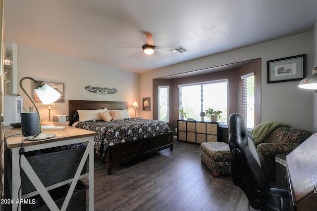 bedroom featuring wood finished floors, visible vents, and a ceiling fan