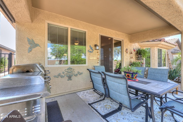 view of patio featuring outdoor dining area and a grill