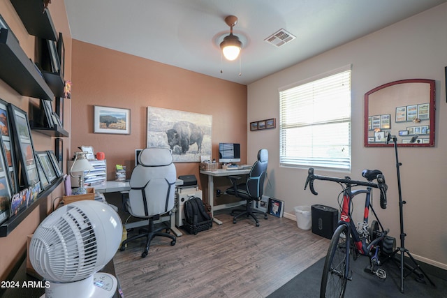 office area featuring ceiling fan, wood finished floors, visible vents, and baseboards