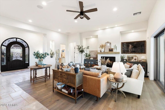 living room with light hardwood / wood-style floors and ceiling fan