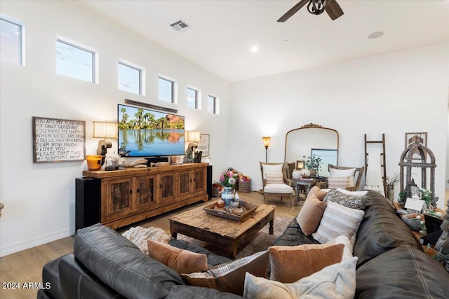 living room with ceiling fan and light hardwood / wood-style flooring