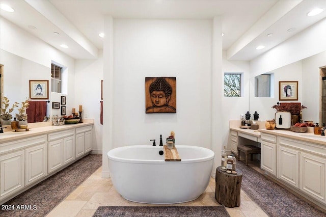 bathroom featuring a tub to relax in and vanity