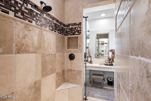 bathroom featuring tile walls and a shower with shower door