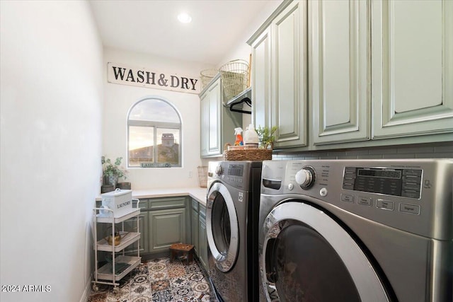 washroom featuring cabinets and washing machine and clothes dryer