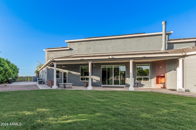 rear view of property featuring a yard and a patio