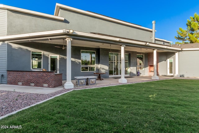 back of property featuring a patio area and a yard