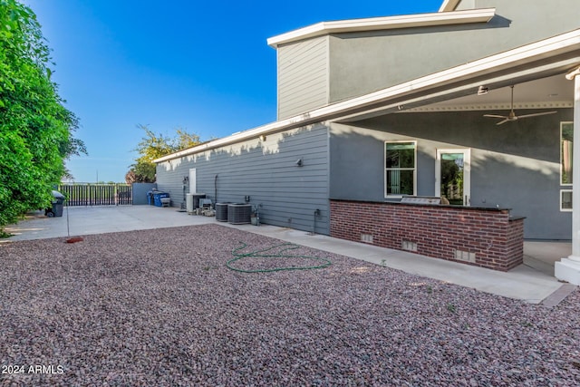 view of home's exterior with a patio area, ceiling fan, and central AC unit