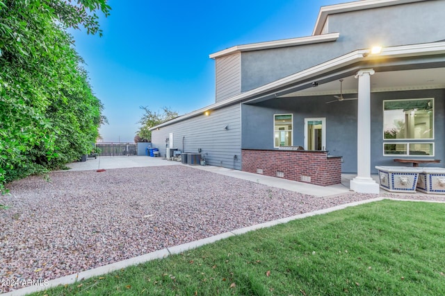 view of home's exterior with ceiling fan and a patio