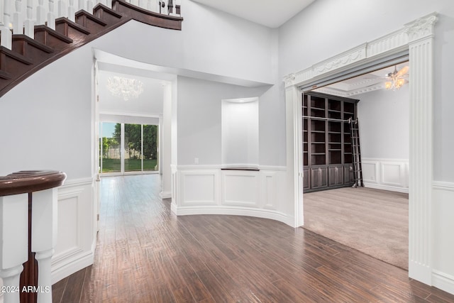 interior space featuring dark colored carpet and an inviting chandelier