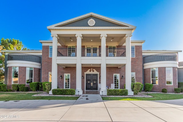 greek revival house with a balcony