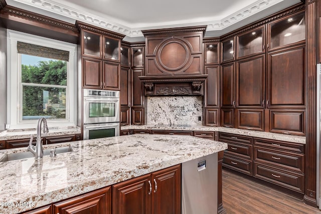 kitchen with dark hardwood / wood-style floors, crown molding, dark brown cabinetry, and sink