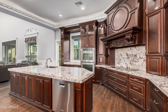 kitchen with sink, dark hardwood / wood-style floors, black electric cooktop, an island with sink, and double oven