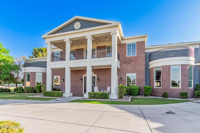 greek revival inspired property with a balcony and central AC