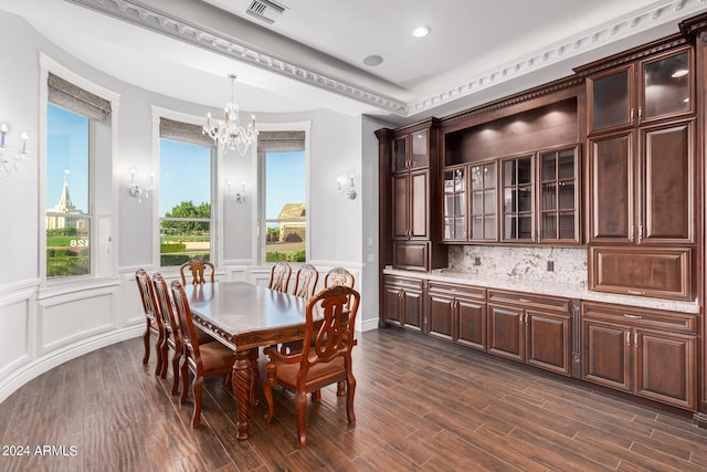 dining room with dark wood-type flooring and an inviting chandelier