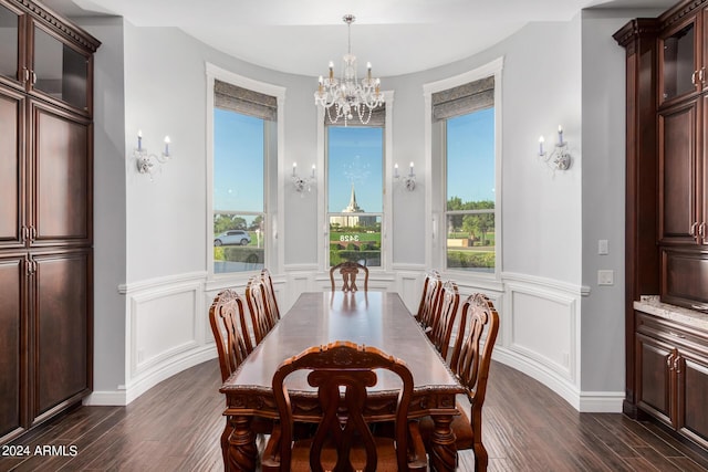 dining room with plenty of natural light, dark hardwood / wood-style flooring, and an inviting chandelier