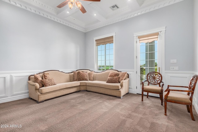 carpeted living room with beamed ceiling, plenty of natural light, coffered ceiling, and ceiling fan