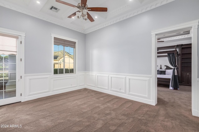 empty room with crown molding, carpet floors, and ceiling fan