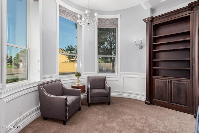 sitting room featuring light carpet and a notable chandelier