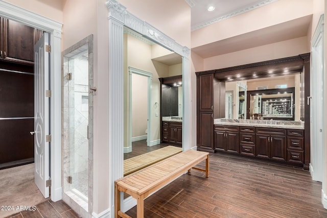 bathroom featuring hardwood / wood-style floors, vanity, toilet, and a shower with door